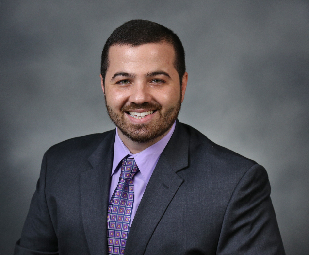 Matthew Baldassano wearing a black suit with purple suit.